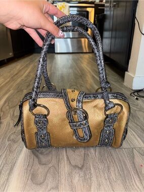 Gold and Black Satchel Handbag with Buckle Detail. Front button does not latch.